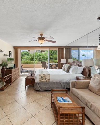 Bright open-plan living room with ceiling fan and ocean view