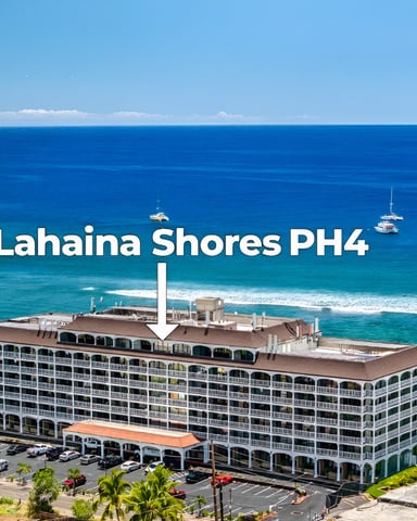 Lahaina Shores PH4 beachfront condominium building with turquoise ocean, sandy beach, and sailboats offshore